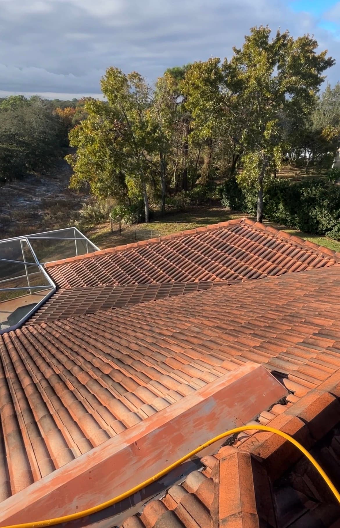 Before: Tile roof covered in dark algae and staining on a home in Spring Hill FL