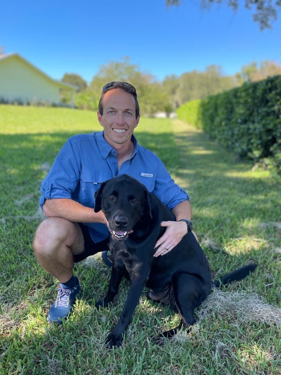 Andrew, owner of Black Lab Power Wash, with his professional pressure washing setup in Brooksville FL
