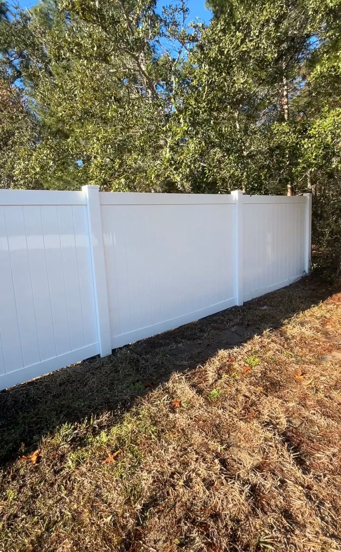 After: Clean white vinyl fence after pressure washing by Black Lab Power Wash in Spring Hill FL