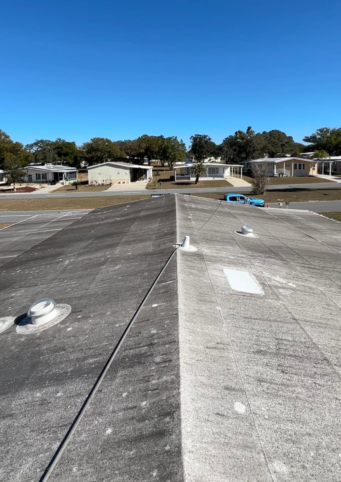 Dirty stained flat roof before soft wash cleaning in Brooksville FL