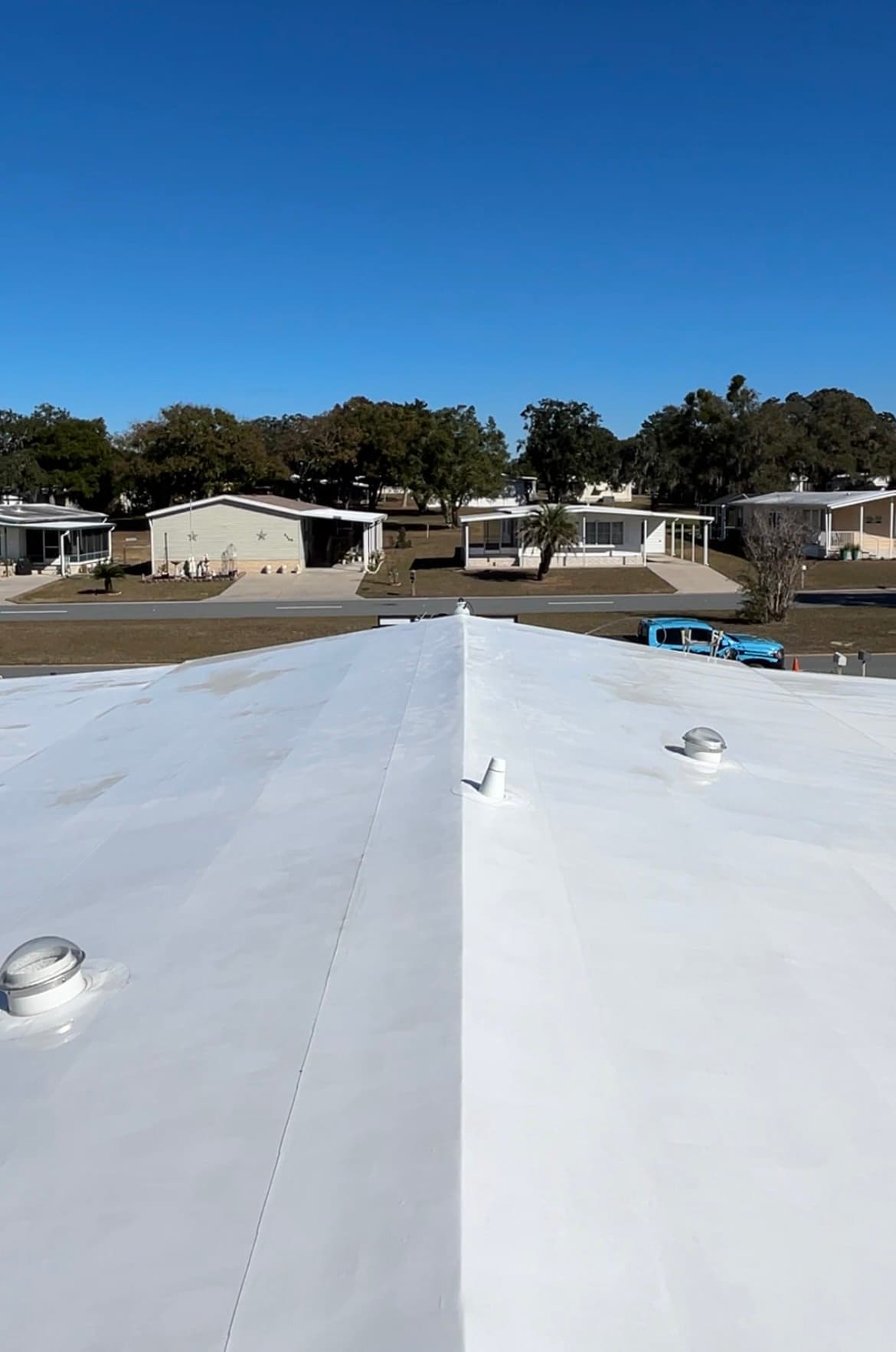 Clean bright white flat roof after soft wash by Black Lab Power Wash in Brooksville FL